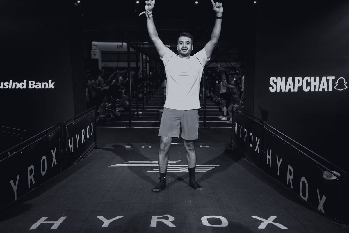 Athlete at the finish line with both arms up